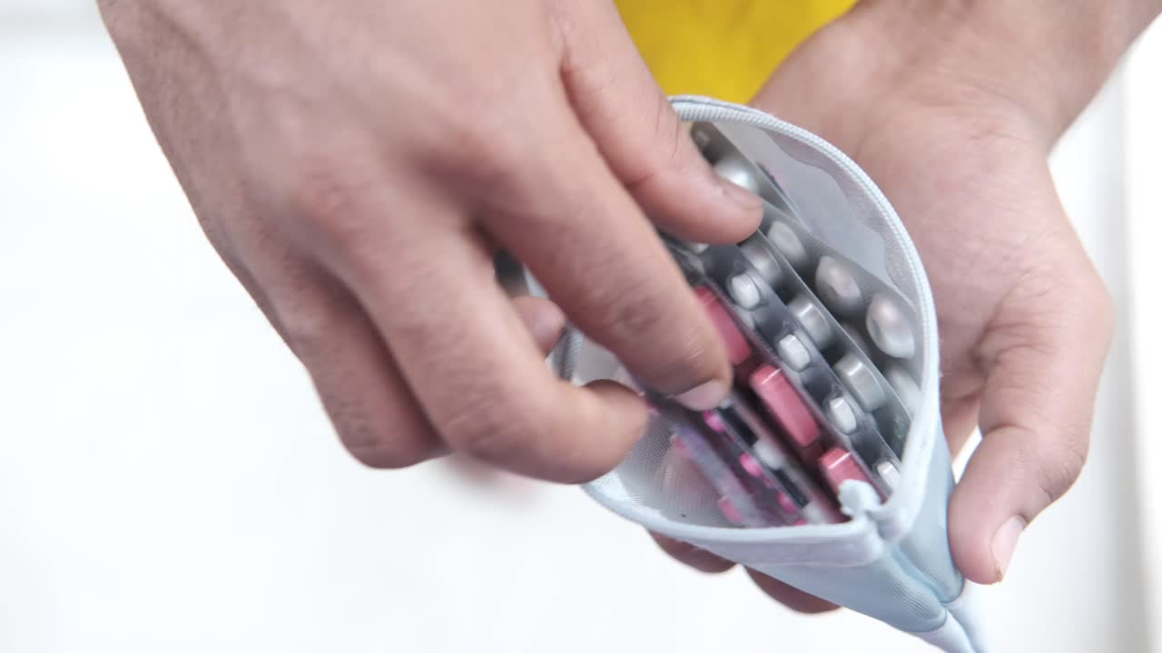 Person holding a pill organizer