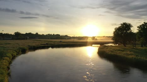 sunrise over a rural landscape with fog