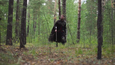 knight walks through forest with bow and arrow