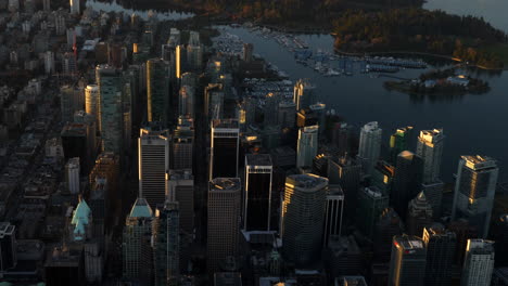 Skyline-Der-Innenstadt-Von-Vancouver-Und-Stanley-Park-Während-Des-Sonnenuntergangs---Luftaufnahme,-Neigung-Nach-Oben