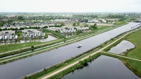 Aerial-footage-of-the-yacht-or-boat-passing-on-the-canal-in-Holland