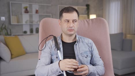 Blind-man-sitting-at-home-drinking-tea.