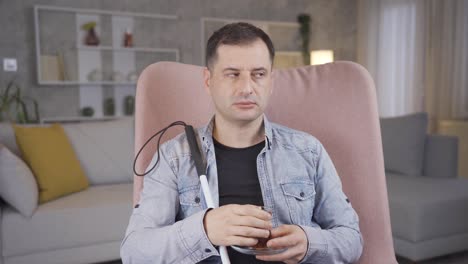 blind man sitting at home drinking tea.