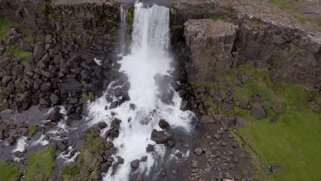 &Ouml;xar&aacute;rfoss waterfall in Iceland aerial pull back shot from birds eye view