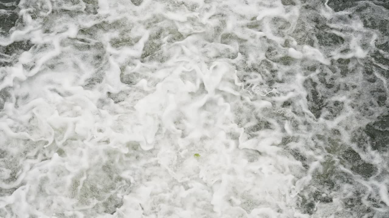 Flowing Stream On The River Dam Splashing Out From The Gateway With Foamy Waves. Tilt-up Shot