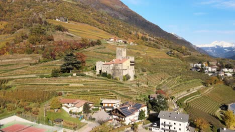 aerial drone over a medieval castle in the middle of the vineyards in italy