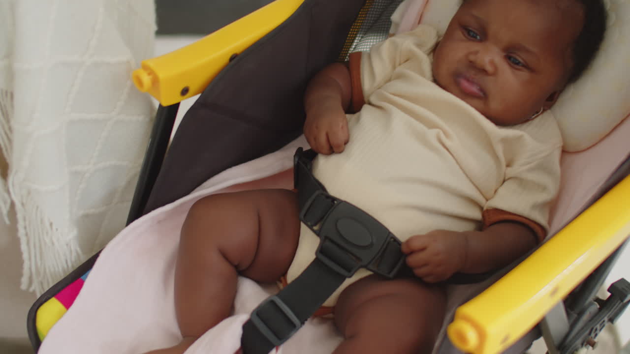 Newborn Girl Resting in Stroller
