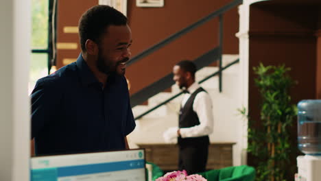 Man-client-at-hotel-front-desk