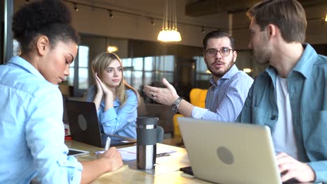 the creative team is discussing a new project. casual young people in new creative business office.