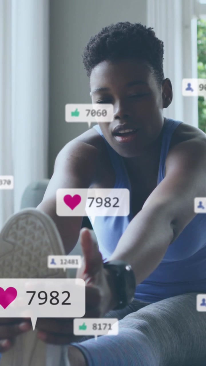 Animation of social media icons and numbers over african american woman exercising at home