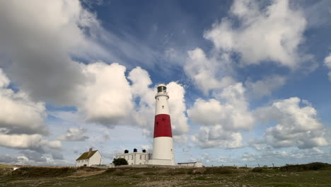 white clouds passing over head of the famous portland bill lighthouse on the south coast of dorset located on the isle of portland