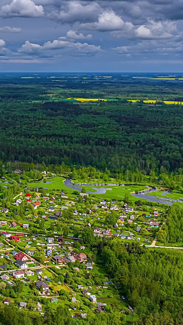 Rural village landscape nature forest alpine resort countryside aerial vertical timelapse