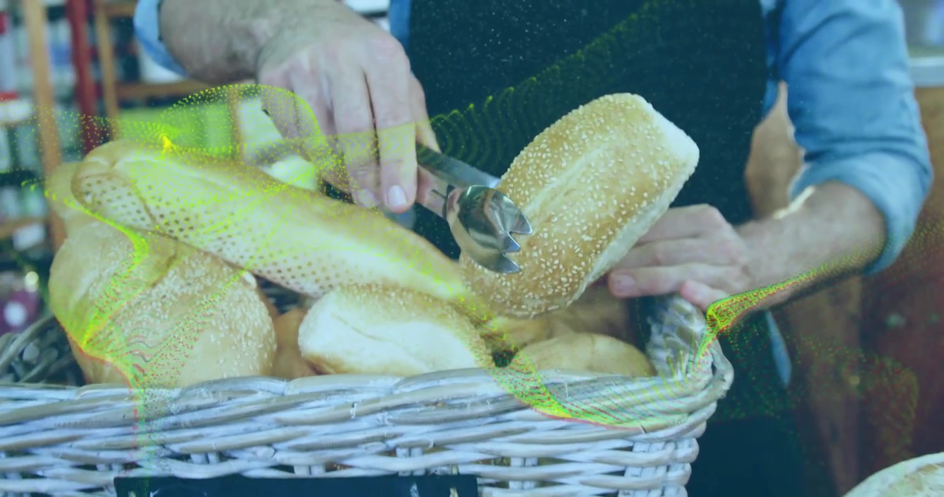 Buyer using tongs initiating selection to serve, bakery staff holding rim, loaves shifting