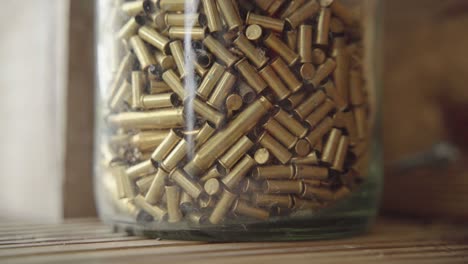 Transparent-plastic-container-full-of-bullet-casings-and-shells