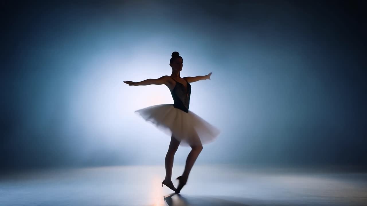 Silhouette of a professional ballerina showcasing graceful ballet movements on stage under a spotlight