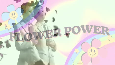 animation of flower power text with rainbow and flowers over figurines of newly wed two gay grooms