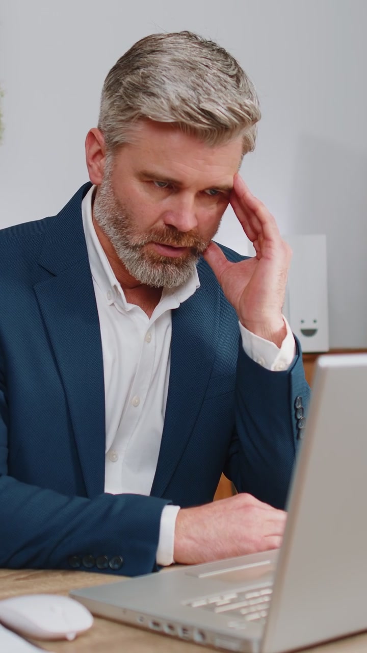 Stressed mature man feeling worried about problem analyzing information bankruptcy money debt