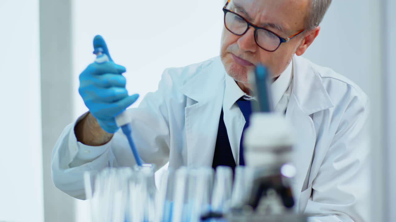 Close up of man scientist using micropipette