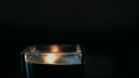 lighting a candle against a black backdrop