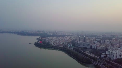 aerial view of a city by a lake at sunset