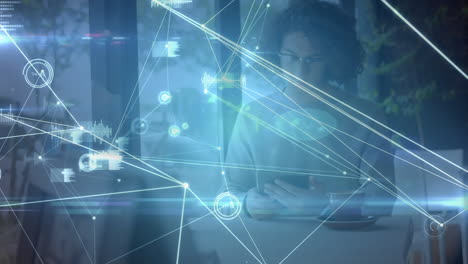 animation of networks of connections with icons over man using tablet