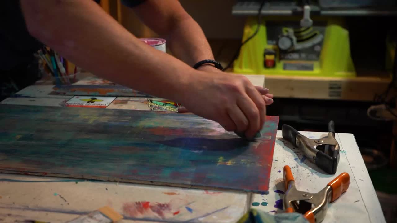 Artist Painting on Wood Panel in Studio