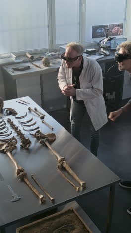 archaeologist examining a skeleton in a laboratory