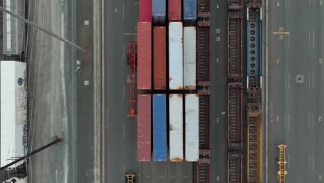 Overhead-aerial-view-lowering-over-loaded-train-carts-in-the-Port-of-Seattle
