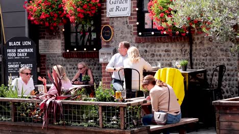 people enjoying drinks at a sunny cafe