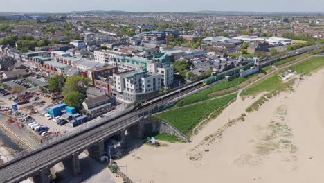 balbriggan beach, train station, and suburban coastal town in fingal, dublin, ireland. - aerial shot