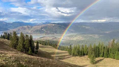 rainbow start place revealed with a slow panning from right to left near durau mountains in romania