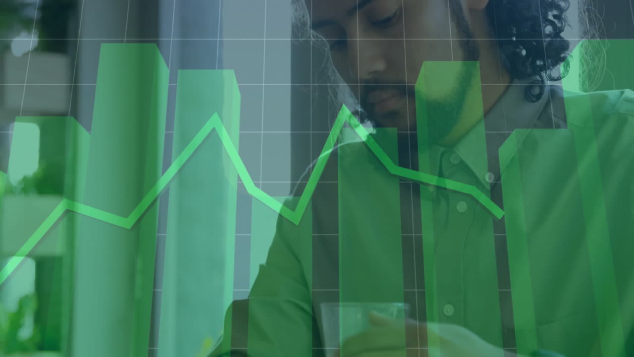 Working at desk, person analyzing green financial graph animation on computer screen
