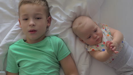 a young boy and his baby sister learning in different ways