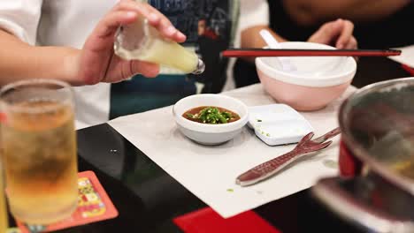 adding garlic sauce to a chilli dish