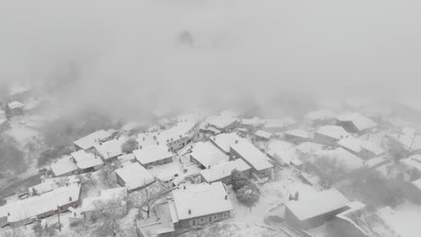 aerial footage over snowy mountain, traditional village in greece 11