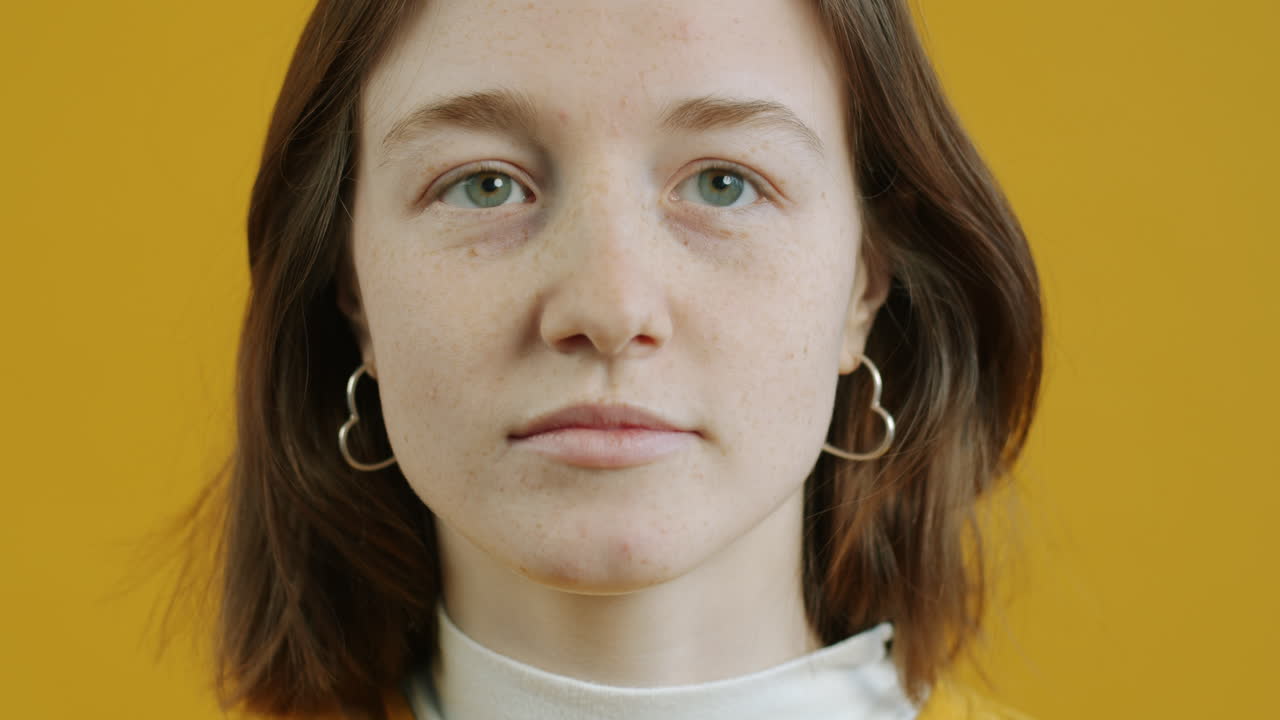 Young Woman with Freckles and Heart-Shaped Earrings