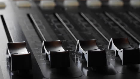 digital audio console. motorized sliders. close up