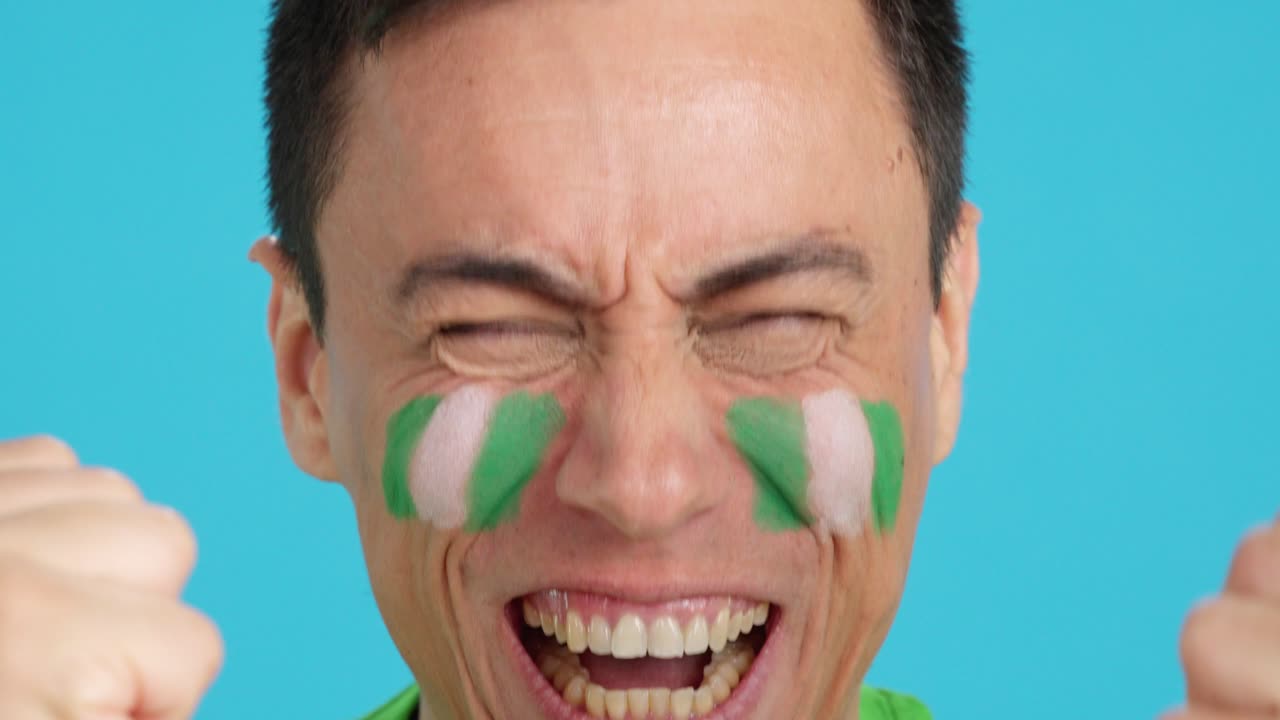 Close up of a man supporting nigerian team