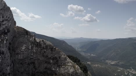 4k panning drone shot over the mountains of hecho valley in the western valleys natural park, aragonese pyrenees, spain. a breathtaking aerial view of the rugged and untouched landscape.