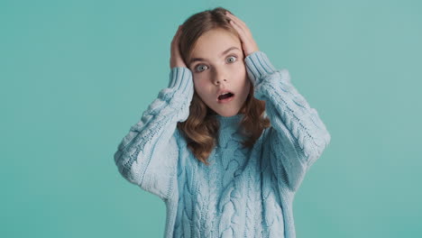 surprised teenage caucasian girl in front of the camera.