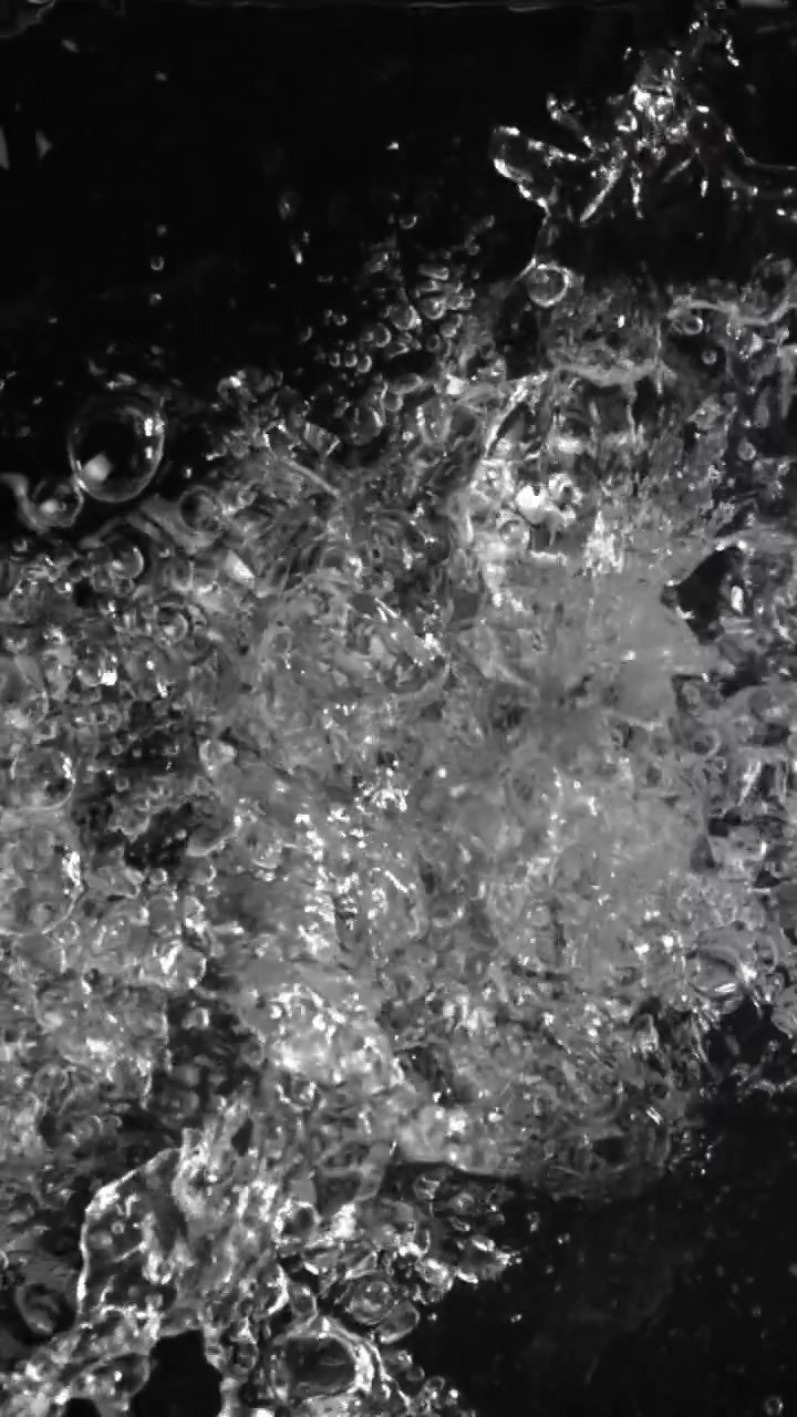 Dynamic Water Splashing and Bubbling on a Black Background