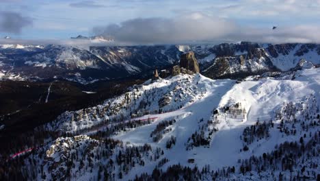 flying in the snow covered italian dolomites on a partly cloudy sunny day