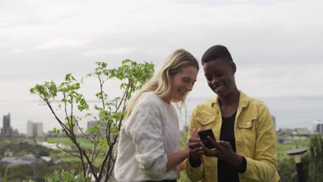 Young-women-taking-a-photo-of-themselves-on-a-roof