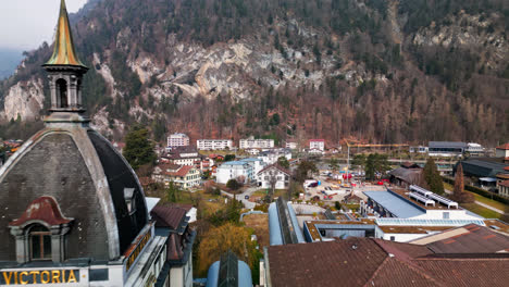 drone pulls away passing classic five star hotel in interlaken switzerland