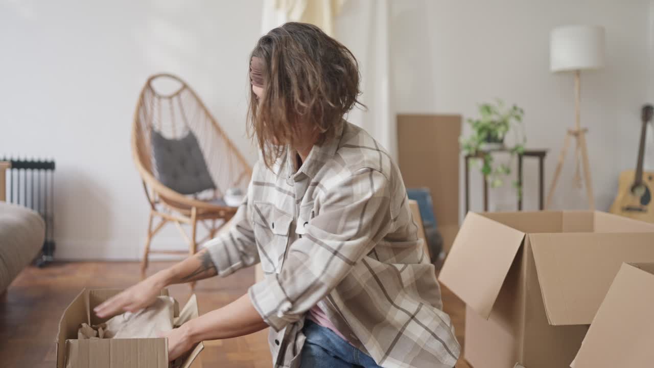 Woman Packing Boxes for a Move