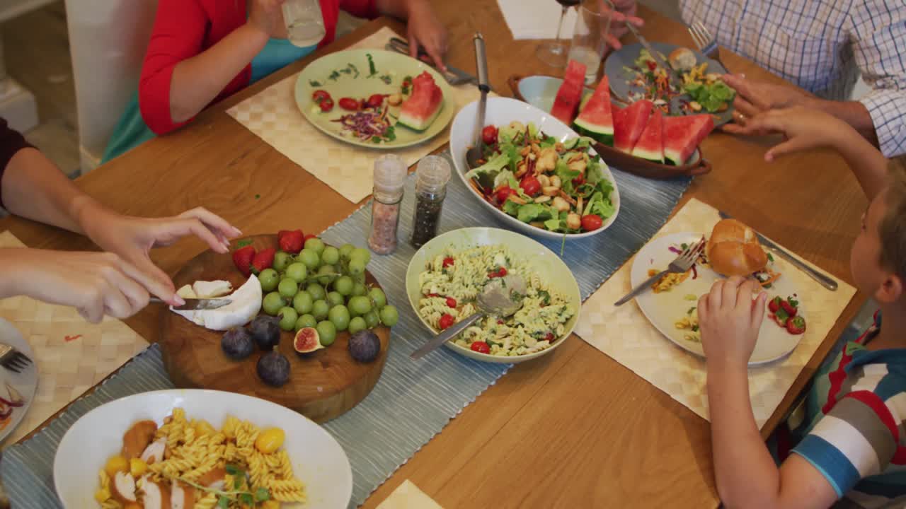 부모, 자녀, 할아버지 가 식탁 에 앉아 가족 식사 를 하고 있다
