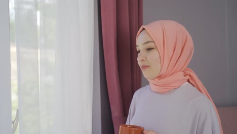 Muslim-woman-looks-out-the-window.