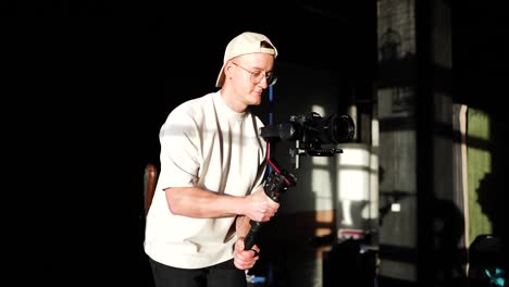 videographer with gimbal stabilizer camera equipment walk smoothly in studio