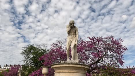 people walking by a statue in paris