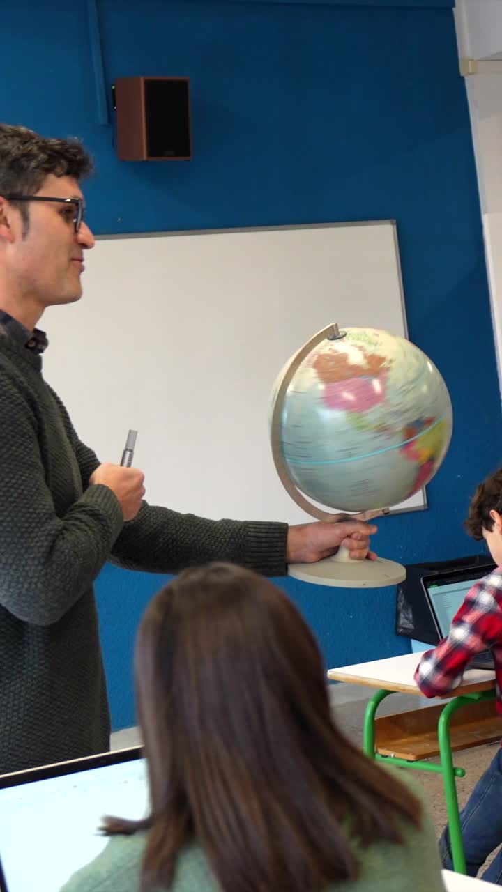 Teacher Explaining Geography with Globe to Students in Classroom